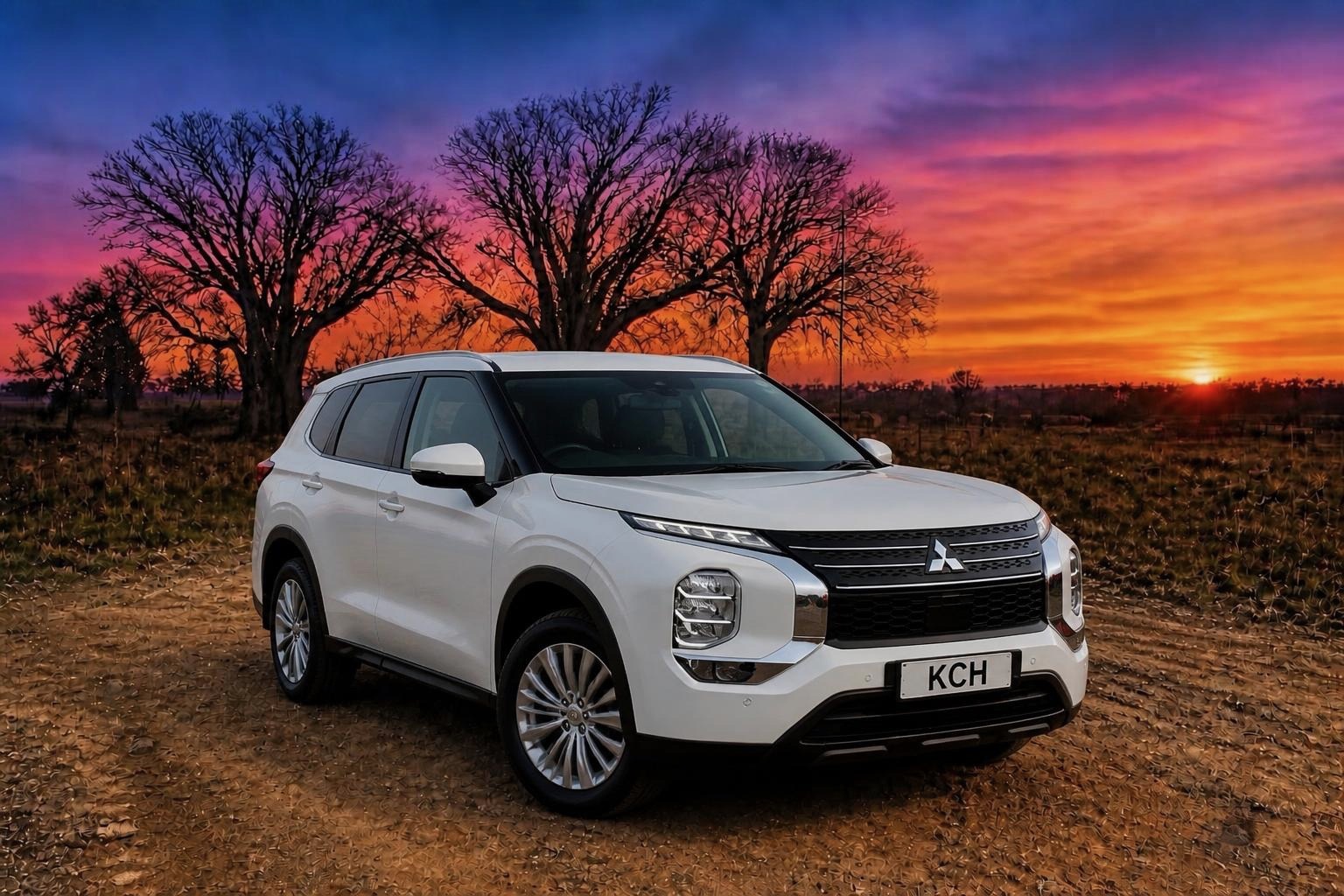 White Mitsubishi Outlander SUV parked on a dirt track with boab trees at sunset