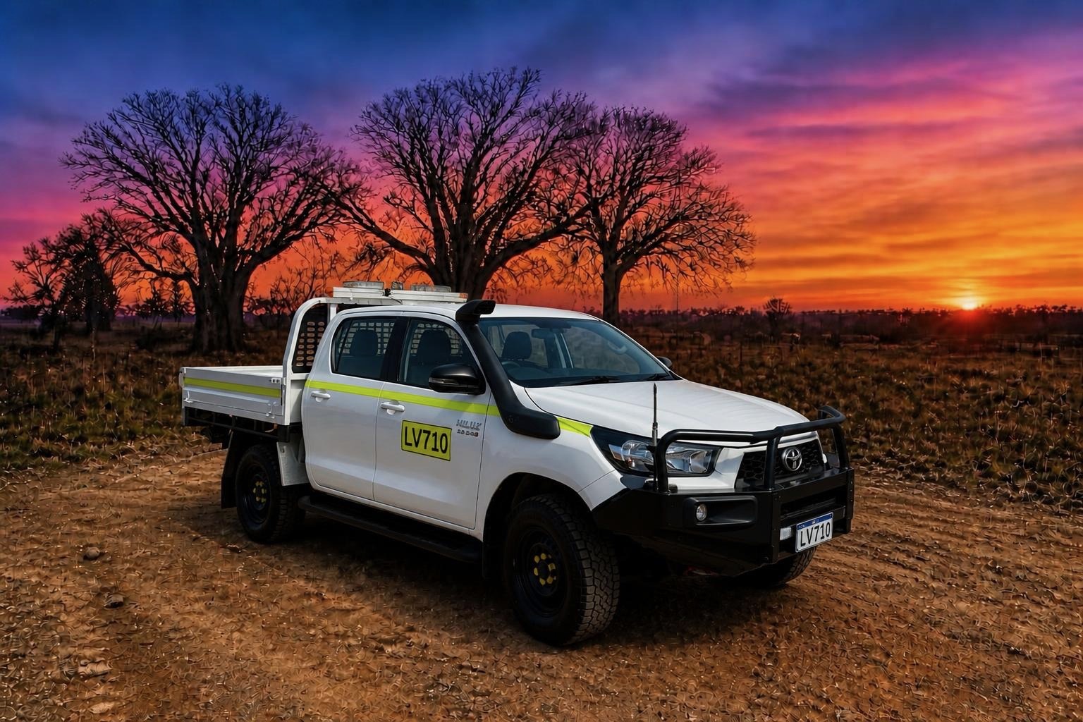 Mine-spec white Toyota Hilux dual-cab ute with roof light bar and high-visibility striping