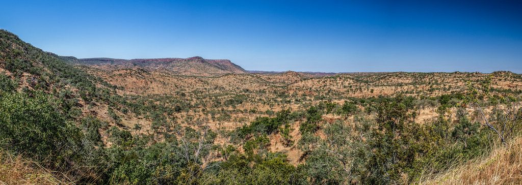 Panorama of rugged ranges and scrub under a clear blue sky